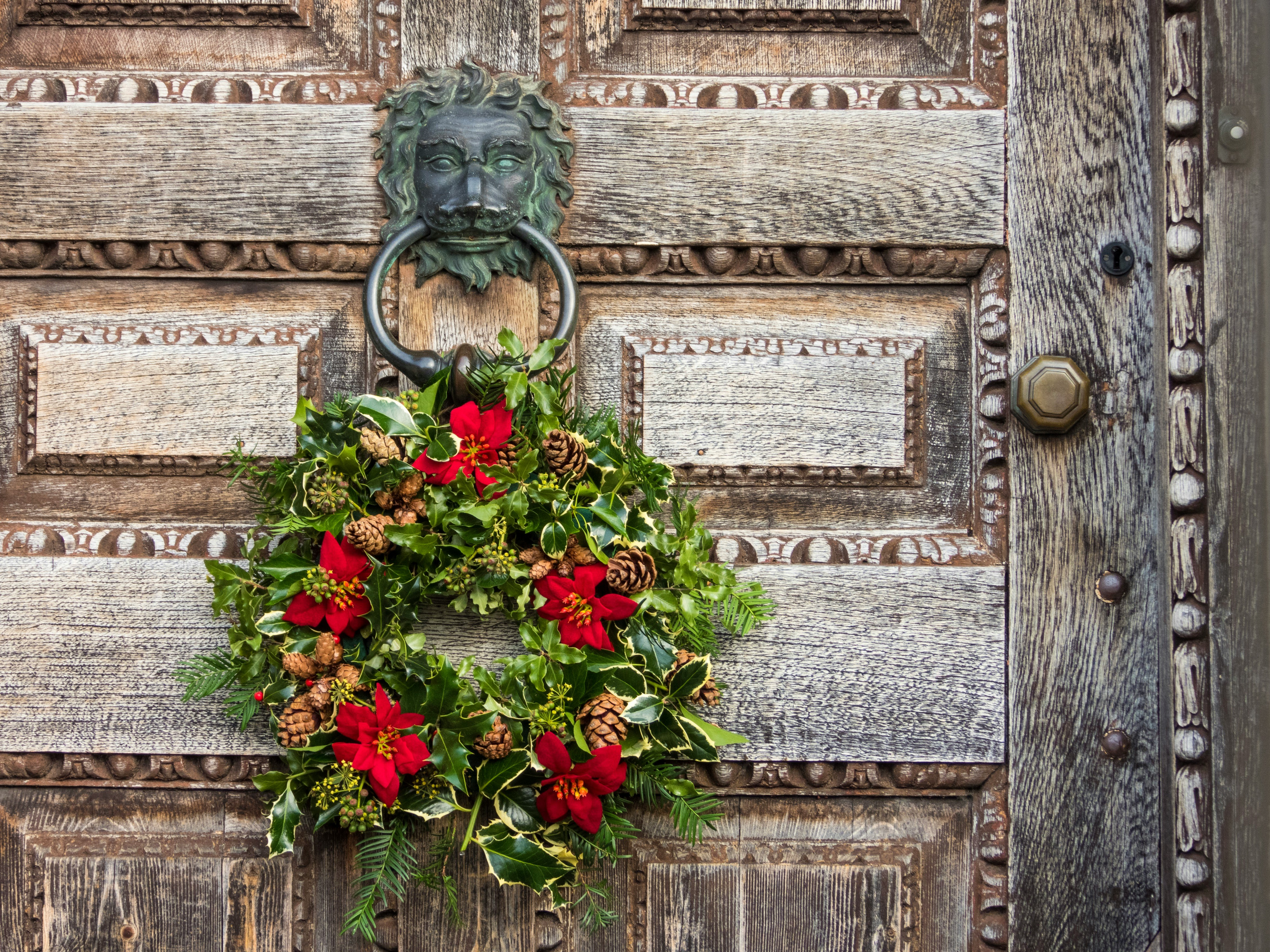 green and red christmas wreath on door knocker